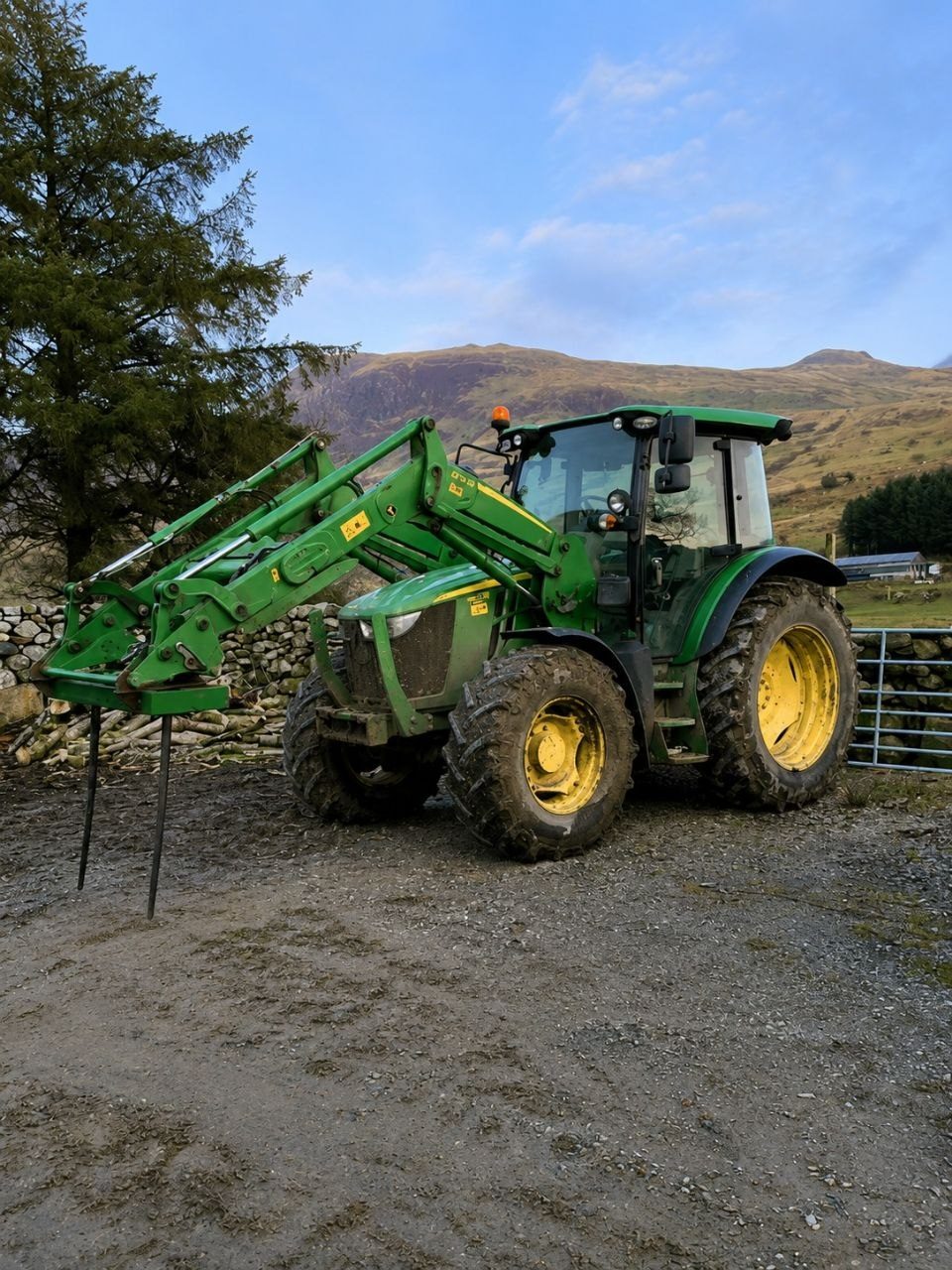John Deere tractor with bale handler in a field